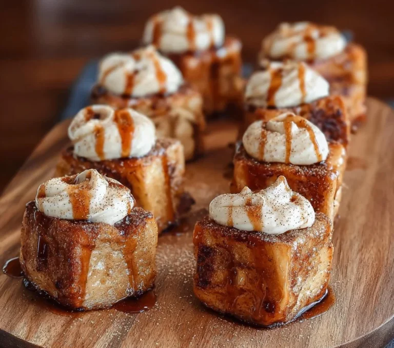 Delicious Cinnamon Roll French Toast Bites served on a plate with syrup and toppings.