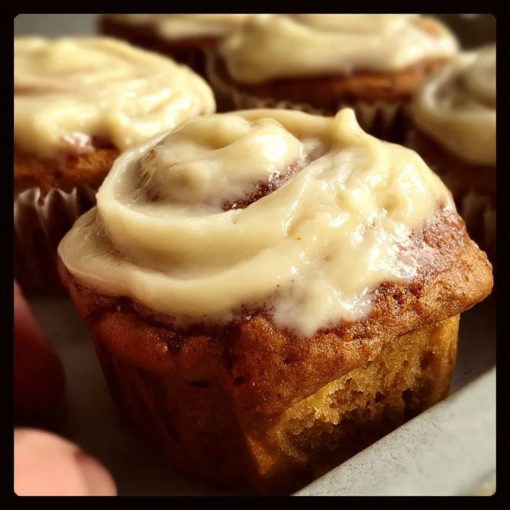 Delicious gluten-free cream cheese frosted muffins on a plate